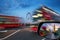 London, England - iconic red double-decker buses on the move on Westminster Bridge with Big Ben and Houses of Parliament