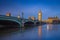 London, England - The iconic Westminster bridge and Big Ben reflecting on River Thames