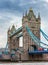 London, England - Tower Bridge, the icon of London on a cloudy morning with traditional red double-decker bus