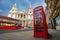 London, England - Traditional red telephone box with iconic red double-decker bus on the move at St.Paul`s Cathedral