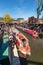 London, England UK - May 14, 2019: Boat navigating to the Regent`s Canal with people around in Camden Lock or Camden