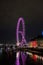 The London Eye  being lit with purple light. Gorgeous lights illuminating the surrounding