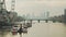 The London Eye and River Thames in warm orange misty sunset light, with Westminster Bridge being ver