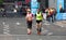 London Marathon, disabled athlete running distance with guide runners in Canary Wharf