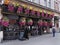 London pubs often have outdoor seating areas decorated with colorful hanging baskets