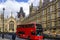 The London Red Bus in front of Westminster Houses of Parliament.