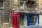 London-style iconic red phone box standing next to run-down old building in Valletta,