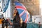 London traveler tourist with a British flag umbrella in London, UK