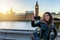 London traveler woman takes selfie pictures at Westminster, UK