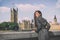 London trench coat business woman at Westminster. Fashion businesswoman in grey raincoat. Asian beauty model outdoor