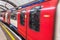 London tube platform edge. Painted warning on the floor. Train passing by.