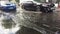 London, UK - 09.20.2018: London flooded road after the rain. Car traffic on the street after the rain.