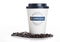 LONDON, UK - APRIL 15, 2019: Closeup of Greggs fairtrade paper coffee cup and sign with lid on white background with beans