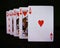 London, UK - April 2020: A royal flush in hearts, standing upright, with the camera focused on the Ace of Hearts.