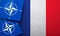 LONDON, UK - August 2022: NATO North Atlantic Treaty Organization military alliance logo on a France flag