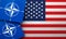 LONDON, UK - August 2022: NATO North Atlantic Treaty Organization military alliance logo on a USA flag