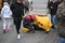 LONDON, UK - February 16, 2018: Exhausted street artist next to his fancy dress counting hard earned money, people walking and loo