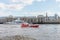 London / UK, July 15th 2019 - Thames Rockets sightseeing speed boat speeding down the Thames River in front of Butlers Wharf