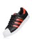 LONDON, UK - JUNE 05, 2019: Adidas Originals Superstar black shoe with red stripes on white background.German multinational