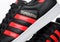 LONDON, UK - JUNE 05, 2019: Adidas Originals Superstar black shoes with red stripes on white background.German multinational