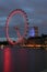 London UK:JUNE 26th 2015,Majestic London Eye and iconic buildings of London at night on the bank of River Thames