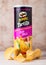 LONDON, UK - JUNE 30, 2018: Pringles potato tortilla chips fieri chilli on wood. Potato and wheat-based stackable snack.