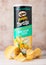LONDON, UK - JUNE 30, 2018: Pringles potato tortilla chips sour cream fiesta on wood. Potato and wheat-based stackable snack.