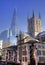 LONDON, UK - MARCH 29, 2014 Southwark Cathedral and Shadr of glass South bank walk of the river Thames Contrast modern and old arc