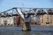 LONDON, UK - MAY 13, 2015: Tourists and commuters walk on the Millennium bridge with St Pauls in the background on a