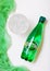 LONDON, UK - OCTOBER 10, 2018 : Bottle of Perrier sparkling water with glass and green cloth. Perrier is a French brand of natural