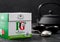 LONDON, UK - OCTOBER 21, 2020: Pack of PG tips black tea with iron teapot and vintage strainer infuser on black