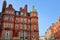 LONDON, UK: Red brick Victorian houses facades in Berkeley Square and Mount Street in the borough of Westminster