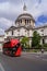 London, UK: a red bus is passing by St Paul`s Cathedral.