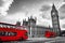 London, the UK. Red buses in motion and Big Ben