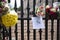 LONDON, UK - September 2022: Flowers and messages of condolence on the gates of Buckingham Palace in tribute to Queen