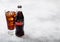 LONDON, UK - SEPTEMBER 28, 2018: Glass and bottle of Coca Cola Zero soda drink with ice cubes and bubbles on stone kitchen table b