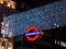 London Underground sign against Christmas illumination background at night.