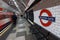 London Underground sign with moving train and people at Lancaster Gate station