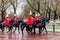 London, United Kingdom - 11/04/2016: Parade Royal Guard on black horses on street in London, after rain, in the background a bit b