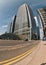 London, United Kingdom - April 06, 2007: Sun shines on empty road near Canary Wharf tube station entrance, tall glass and steel.