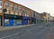 London, United Kingdom - April 09, 2020: Line of shops with shutters closed on Lewisham High street during coronavirus outbreak.