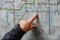 London, United Kingdom - February 02, 2019: Senior woman hand pointing to Canada Water station on London Tube map, as she plans