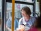 London, United Kingdom- June 2019: Street Photography: Elderly Lady with Glasses Sitting on City Bus in London