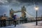 London winter concept with a tourist holding a british flag umbrella standing in front of the Tower Bridge