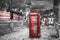 London in winter time: red telephone cells with falling snow