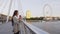 London woman drinking coffee on bridge over the Thames