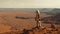 A lone astronaut standing on the surface of the red planet Mars. He looks around and observes the breathtaking view.