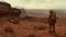 A lone astronaut standing on the surface of the red planet Mars. He looks around and observes the breathtaking view.