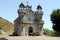 Lone bay horse walking by the Church of Santo Antonio de Mixoes da Serra, in the highland village, Valdreu, Portugal