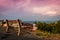 A lone bench faces the mountains under a stormy sunset at High Point State Park